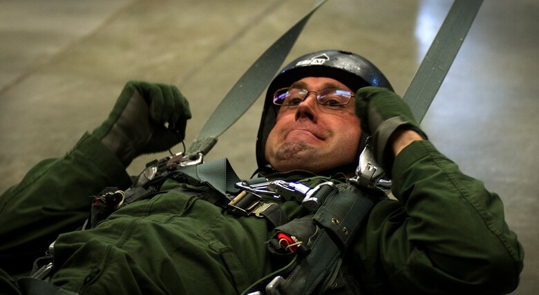 Staff Sgt. Erik Nosich, 144th Airlift Squadron loadmaster stationed at Joint Base Elmendorf-Richardson Alaska, practices being dragged by a parachute May 26, 2016, at Fairchild Air Force Base, Wash. The parachuting program’s goal is to train all aircrew members, who could potentially have to bail out of their aircraft, on how to survive a parachute ride so they can be recovered by recovery personnel.  (U.S. Air Force photo/Airman 1st Class Sean Campbell)
