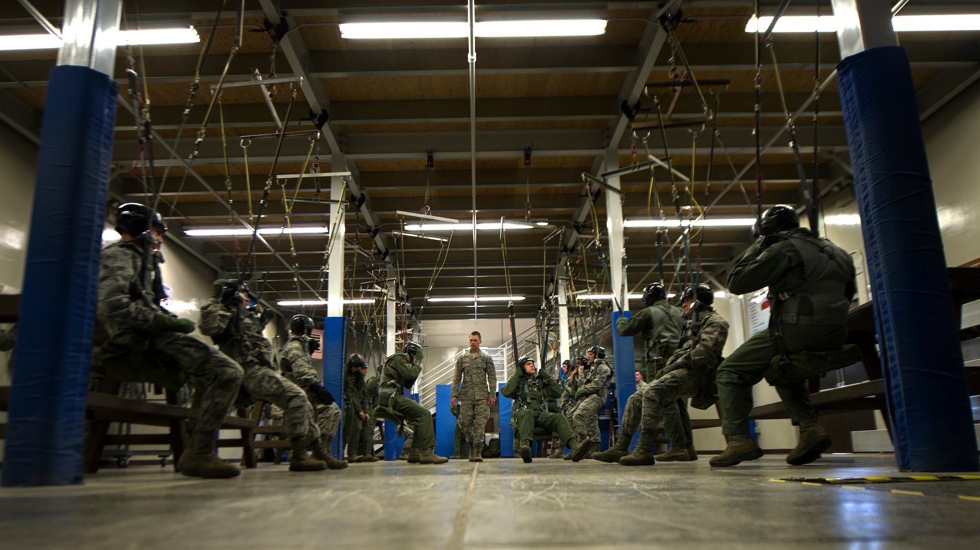 Senior Airman Nathan Zeiger, 22nd Training Squadron Survival, Evasion, Resistance and Escape specialist, instructs a parachuting lab May 26, 2016, at Fairchild Air Force Base, Wash. The last step of the training is where students learn how to fall. They are instructed on proper falling procedures that include keeping the feet and knees together and making five points of contact when hitting the ground. (U.S. Air Force photo/Airman 1st Class Sean Campbell)

