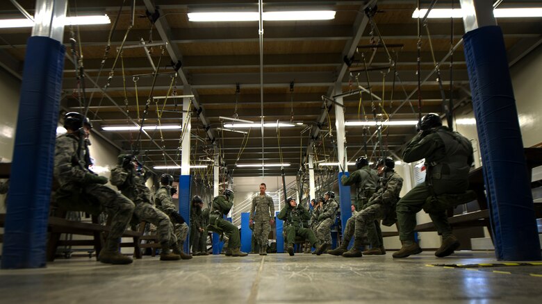 Senior Airman Nathan Zeiger, 22nd Training Squadron Survival, Evasion, Resistance and Escape specialist, instructs a parachuting lab May 26, 2016, at Fairchild Air Force Base, Wash. The last step of the training is where students learn how to fall. They are instructed on proper falling procedures that include keeping the feet and knees together and making five points of contact when hitting the ground. (U.S. Air Force photo/Airman 1st Class Sean Campbell)

