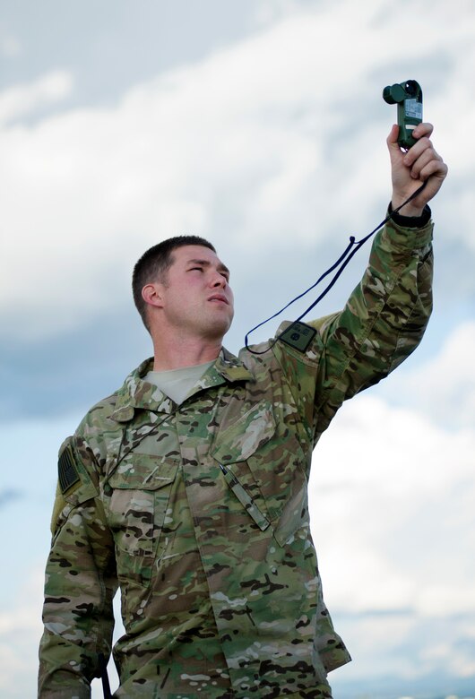 Staff Sgt. Corey Wagner, 22nd Training Squadron Survival, Evasion, Resistance and Escape instructor, tests winds before a jump May 25, 2016, at Fairchild Air Force Base, Wash. Instructors of the Emergency Parachuting course make sure students who come to the course leave being able to do everything they need if they find themselves in an emergency parachuting situation. (U.S. Air Force photo/Airman 1st Class Sean Campbell)