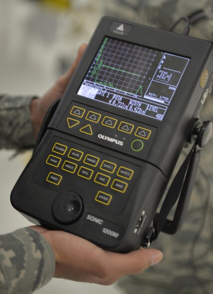 Senior Airman Santiago De La Rosa, 33rd Maintenance Squadron nondestructive inspection journeyman, checks the readings on a Sonic 1200 unit during the inspection of an F-35A Lightning II panel at Eglin Air Force base Fla., May 16, 2016. The Sonic 1200 displays the depth of damage inside the metal of the aircraft. Equipment like the transducers, x-rays and ultrasound machines used by NDI Airmen seek out metal fatigue unseen by the naked eye. (U.S. Air Force photo/Senior Airman Andrea Posey)