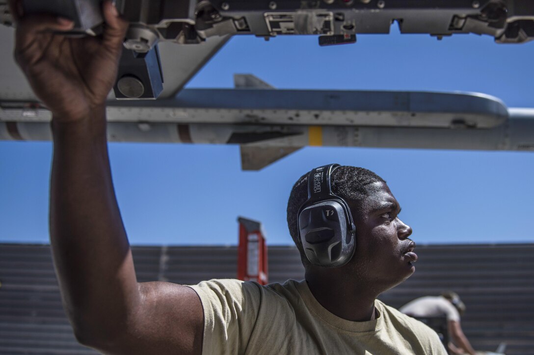 Air Force Senior Airman Clarence Williams uploads a guided bomb unit on an F-16C Fighting Falcon at Bagram Airfield, Afghanistan, June 7, 2016. Williams is a weapons maintainer assigned to the 455th Expeditionary Aircraft Maintenance Squadron. The weapons team ensures pilots have the correct and functional munitions to provide the air cover ground forces need. Air Force photo by Senior Airman Justyn M. Freeman