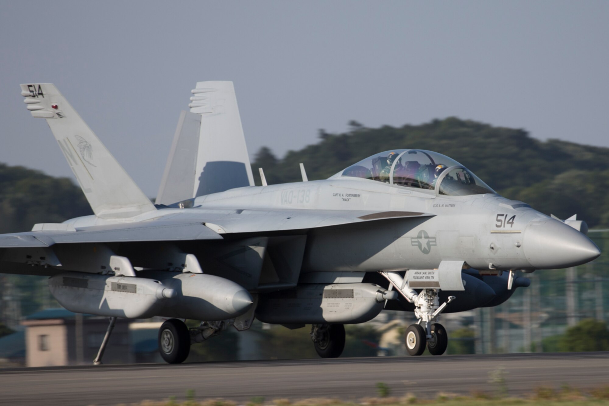 A Navy EA-18G Growler, assigned to the Electronic Attack Squadron (VAQ) 138, deploys a J-Hook to engage the aircraft arresting cable at Yokota Air Base, Japan, June 3, 2016, during the annual aircraft arresting barrier system test. The 374th Civil Engineer Squadron power productions shop and fire department and the 374th Operations Support Squadron airfield management flight are responsible for the annual test. (U.S. Air Force photo by Yasuo Osakabe/Released)