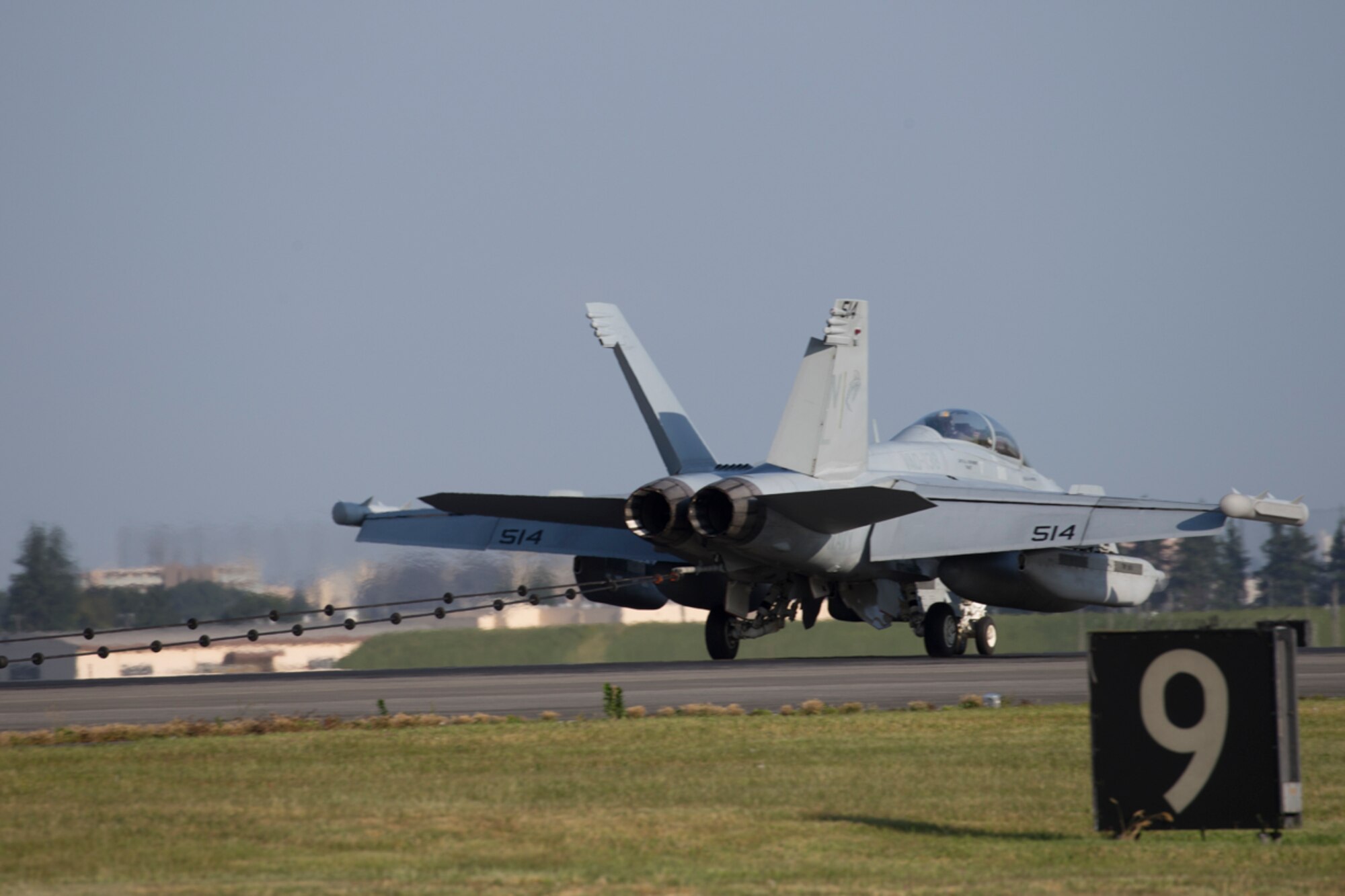 A Navy EA-18G Growler, assigned to the Electronic Attack Squadron (VAQ) 138, catches the cable during an annual certification test of an aircraft arresting system at Yokota Air Base, Japan, June 3, 2016. The system went through an annual certification test to ensure its operability following installation by the 374th Civil Engineer Squadron power productions shop. (U.S. Air Force photo by Yasuo Osakabe/Released)