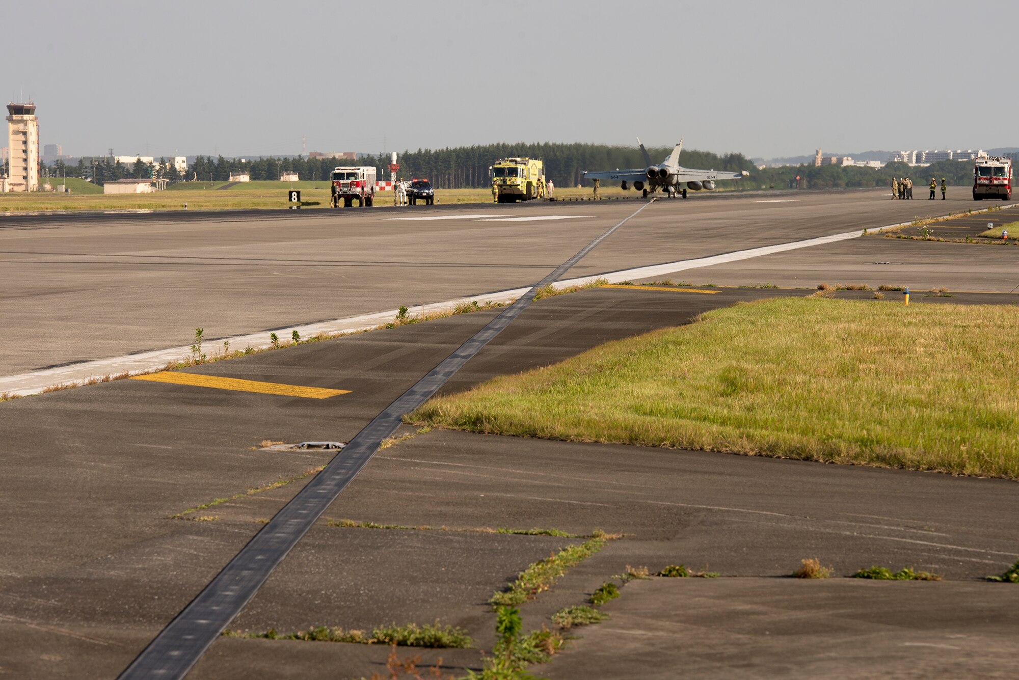 Airmen with the 374th Civil Engineer Squadron practice responding to in-flight emergency landing during an aircraft arresting system test certification at Yokota Air Base, Japan, June 3, 2016. The 374 CES and 374th Operations Support Squadron airfield management flight are responsible for testing the system annually. (U.S. Air Force photo by Senior Airman David C. Danford/Released)
