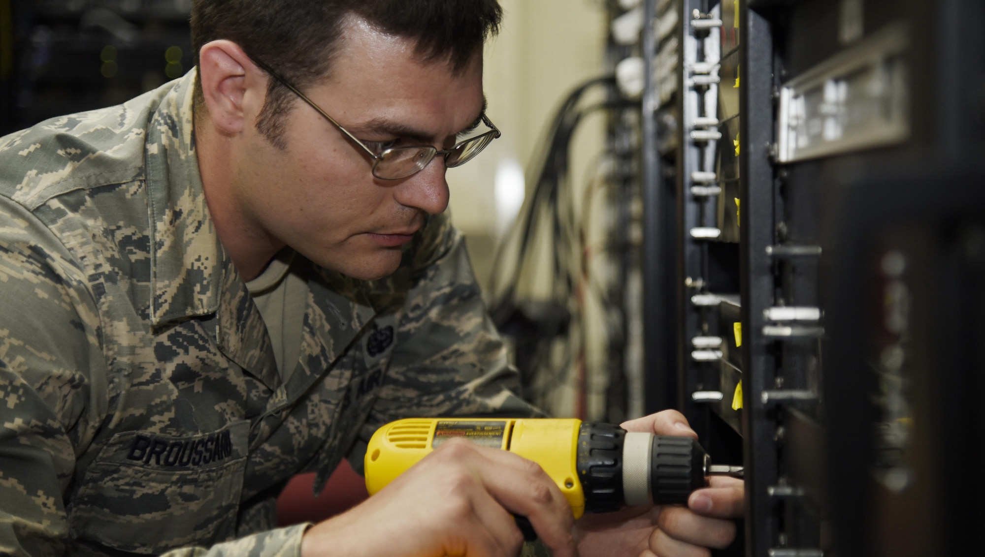 U.S. Air Force Staff Sgt. Samuel Broussard, the broadcast system maintenance NCO in charge with American Forces Network Misawa, screws in a piece of equipment during system maintenance at Misawa Air Base, Japan, June 7, 2016. Working as a broadcast system maintenance technician at an AFN detachment is a special duty assignment for technology communications Airmen. These Airmen ensure all video, radio and broadcast equipment functions correctly at all times. Broussard hails from West Monroe, Louisiana. (U.S. Air Force photo by Airman 1st Class Jordyn Fetter)