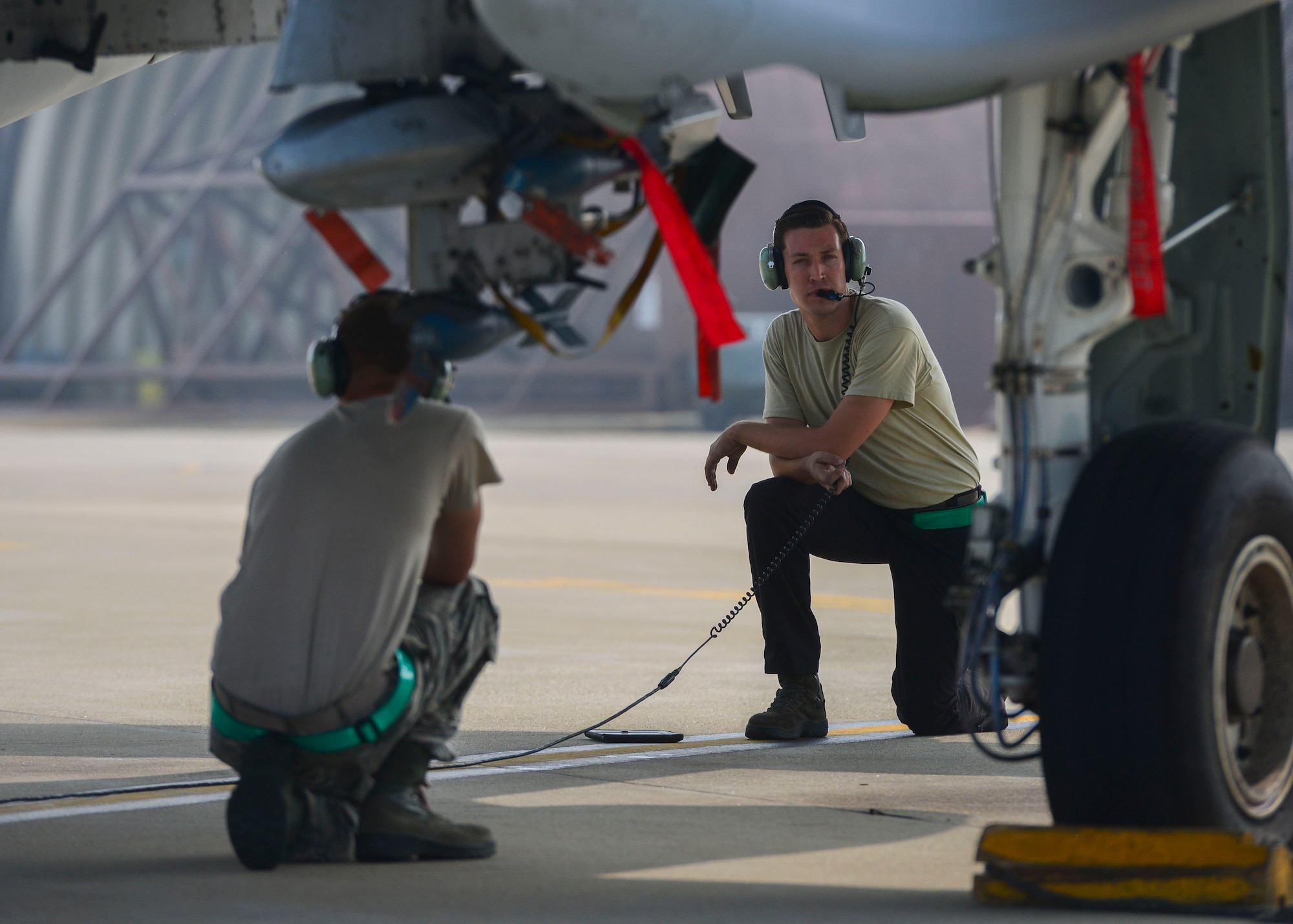 Airman Weston Meyer and Senior Airman Paul Willett, 51st Aircraft Maintenance Squadron crew chiefs, wait underneath an A-10 Thunderbolt II while the pilot runs a pre-flight checklist at Osan Air Base, Republic of Korea, June 9, 2016. Maintenance Airmen are responsible for keeping 51st Fighter Wing aircraft in top condition and ready to fight tonight. (U.S. Air Force photo by Senior Airman Victor J. Caputo/Released)