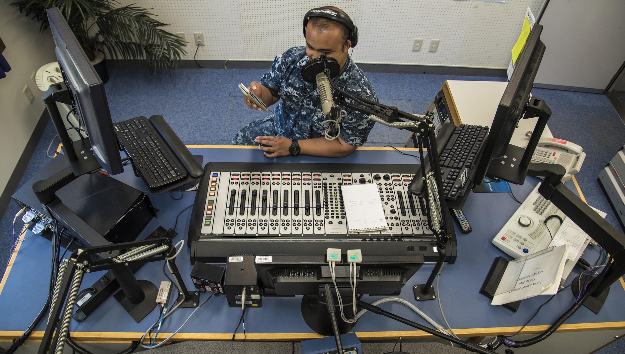 U.S. Navy Petty Officer 2nd Class Dean Cates, the radio NCO in charge with American Forces Network Misawa, quotes facts for a radio show at Misawa Air Base, Japan, June 7, 2016. Radio shows occur twice a day for four hours, during which the radio host aims to be an extension of the base commander’s voice by sharing priorities, event information and interesting facts. Although the radio station 1575 AM plays only one song at a time, AFN provides access to other music genres and radio shows online and through a mobile phone application available on iOS and Android. Cates is from San Francisco, California. (U.S. Air Force photo by Airman 1st Class Jordyn Fetter)