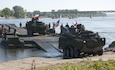 U.S. and U.K. Strykers are ferried across the Vistula River near Chelmno, Poland in a demonstration of the Amphibious Rig capabilities June 7 as part of a multinational event during Exercise Anakonda 2016. The ferries are created by connecting six Amphibious Rigs together, which are then capable of transporting military vehicles or supplies across a body of water.  Anakonda 2016 is a Polish-led, joint multinational exercise taking place throughout Poland June 7-17. The exercise involves more than 25,000 participants from more than 20 nations. Anakonda 2016 is a premier training event for U.S. Army Europe and participating nations and demonstrates the United States and partner nations can effectively unite under a unified command while training on contemporary scenario. (U.S. Army photo by Staff Sgt. Debra Richardson (Released)