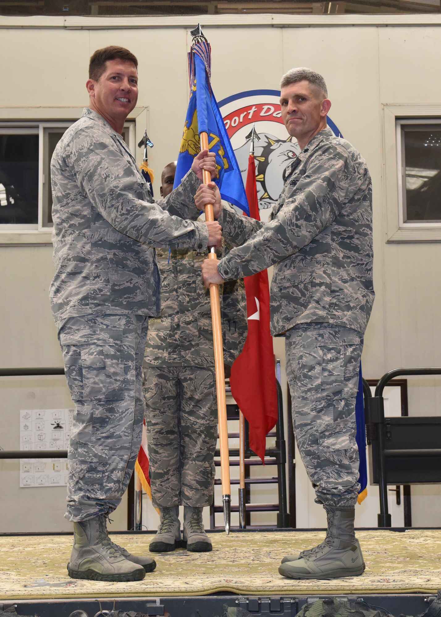 Col. Timrek Heisler, 521st Air Mobility Operations Group commander, passes the guidon to Lt. Col. Nathan Mansfield, 728th Air Mobility Squadron commander, during the 728th AMS change of command ceremony June 9, 2016, at Incirlik Air Base, Turkey. A change of command ceremony is a tradition that represents a formal transfer of authority and responsibility from the outgoing commander to the incoming commander. (U.S. Air Force photo by Airman 1st Class Devin M. Rumbaugh/Released) 