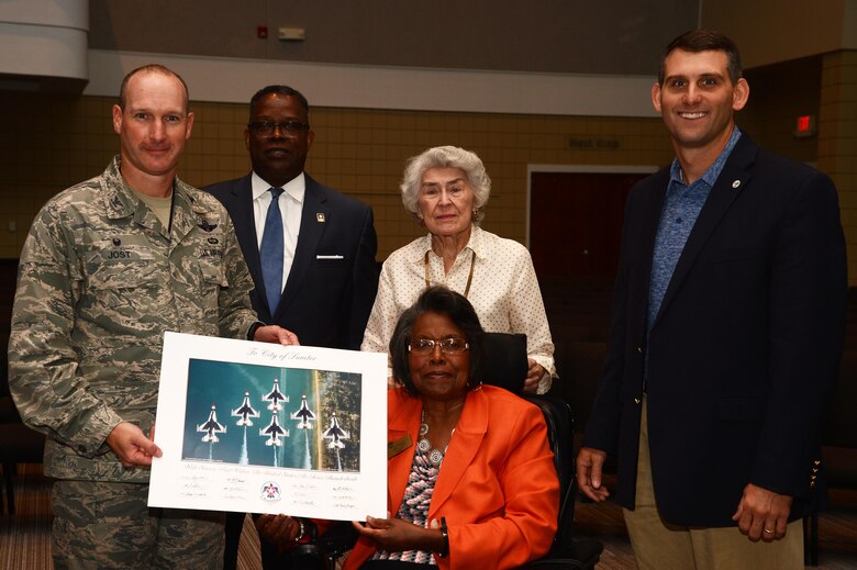 U.S. Air Force Col. Stephen Jost, 20th Fighter Wing commander, presents a lithograph from the U.S. Air Force Aerial Demonstration Squadron, the Thunderbirds, to members of the Sumter City Council during the Greater Sumter Chamber of Commerce Commander’s Breakfast at Alice Drive Baptist Church, Sumter, S.C., June 8, 2016. Jost thanked the city for their support during the Shaw Air Expo and open house, where the Thunderbirds were one of the headliners. (U.S. Air Force photo by Senior Airman Jonathan Bass)