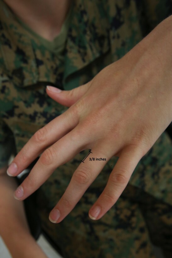 As of June 1, 2016, Marine Corps Bulletin 1020 updated the tattoo policy with the intention of balancing the desires of individual Marines and the standards and professionalism the Marine Corps upholds. Marines are prohibited from getting tattoos on the head, neck, inside the mouth, wrists, knees, elbows and hands with the exception of a single band tattoo of no more than three-eighths of an inch in width on one finger. (U.S. Marine Corps photo illustration by Lance Cpl. Miranda Faughn/Released)
