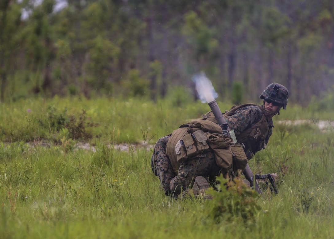 A mortar team with 1st Battalion, 2nd Marine Regiment, take cover on the firing line as a mortar round shoots out of the barrel during a training exercise at Camp Lejeune, N.C., June 6, 2016. Marines underwent mortar familiarization and proficiency training in preparation for their upcoming deployment in support of Special-Purpose Marine Air-Ground Task Force. 