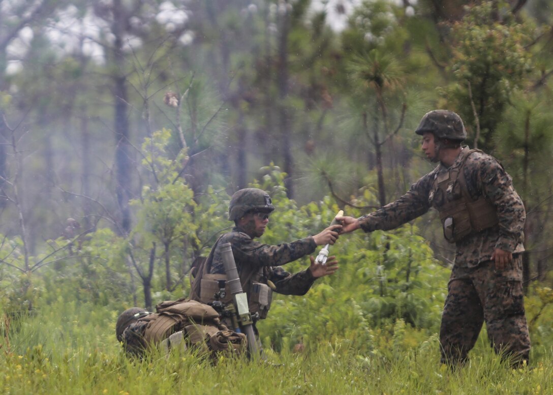 A mortarman with 1st Battalion, 2nd Marine Regiment, 2nd Marine Division, receives a primed mortar round during a training exercise at Camp Lejeune, N.C., June 6, 2016. Marines underwent mortar familiarization and proficiency training in preparation for their upcoming deployment in support of Special-Purpose Marine Air-Ground Task Force. 
