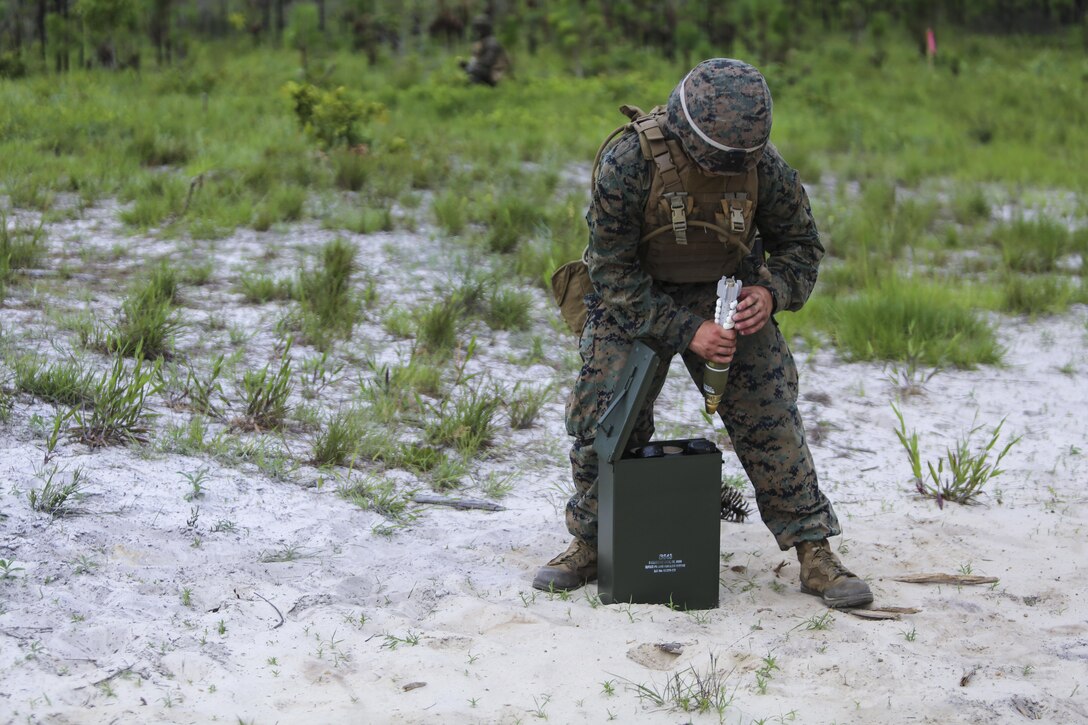 A mortarman with 1st Battalion, 2nd Marine Regiment, 2nd Marine Division, primes a mortar round before handing it off to a gunner for firing at Camp Lejeune, N.C., June 6, 2016. Marines underwent mortar familiarization and proficiency training in preparation for their upcoming deployment in support of Special-Purpose Marine Air-Ground Task Force. 