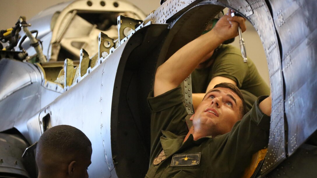 Cpl. Nicholas Stone performs maintenance on a AV-8B Harrier inside the Marine Attack Training Squadron 203 hangar at Marine Corps Air Station Cherry Point, North Carolina, June 8, 2016. During the past three years, VMAT-203 has trained more than 130 AV-8B pilots and 2,000 AV-8B maintenance personnel. Within that time period, the squadron has flown over 12,000 flight hours, participated in four deployments for instructor and student training and received the Commandant's Aviation Efficiency Award. Stone is a fixed wing aircraft airframe mechanic with the Squadron.