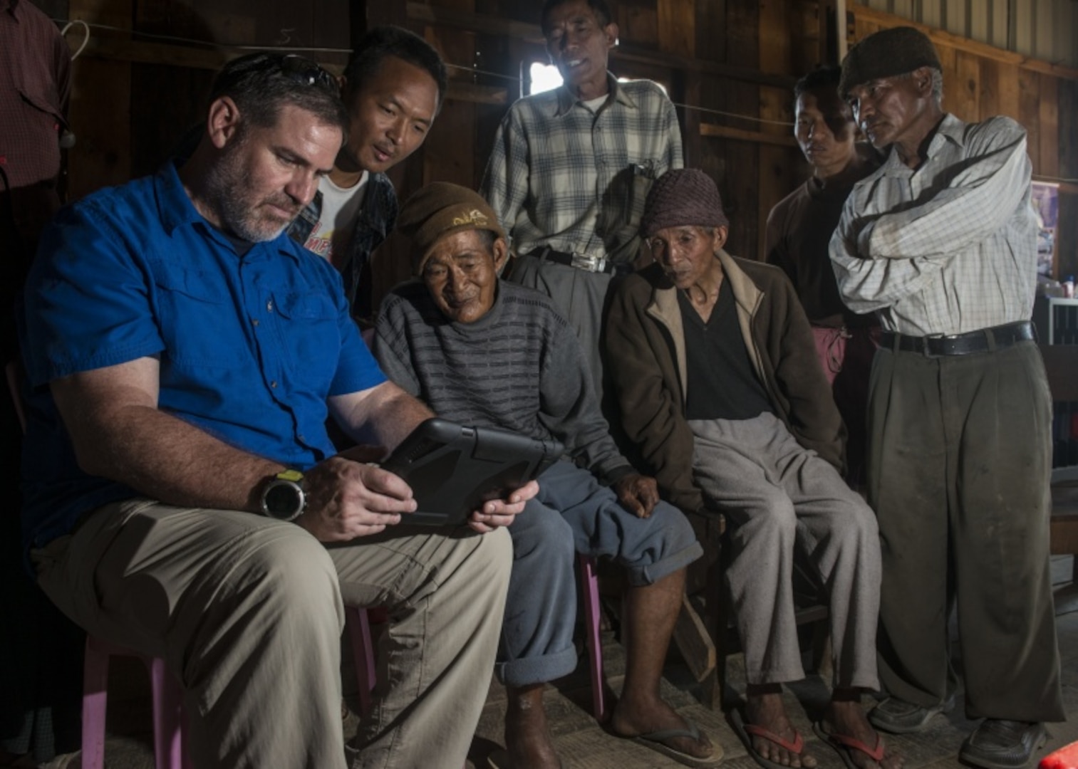 Timothy Kelliher, an analyst and investigation leader with the Defense POW/MIA Accounting Agency (DPAA), shows photos of U.S. aircrafts to a possible witness during a DPAA investigation mission in Chin State, Myanmar, May 9, 2016. Kelliher and eight DPAA team members deployed to the area in hopes of recovering the remains of seven U.S. Army Air Forces personnel unaccounted-for from World War II. The mission of DPAA is to provide the fullest possible accounting for our missing personnel to their families and the nation. 