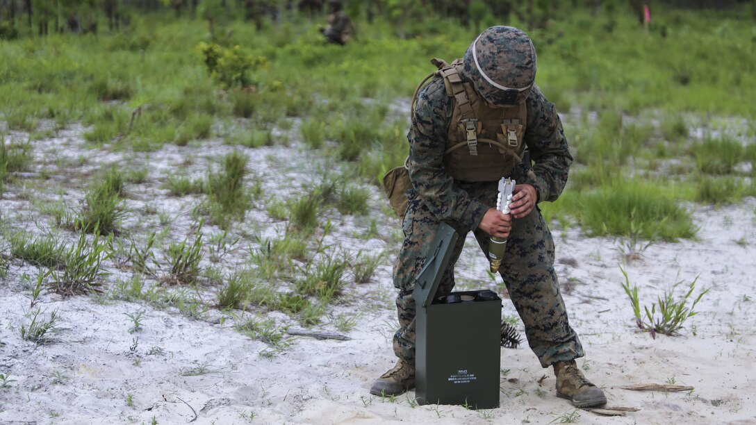 A mortarman with 1st Battalion, 2nd Marine Regiment, 2nd Marine Division, primes a mortar round before handing it off to a gunner for firing at Camp Lejeune, N.C., June 6, 2016. Marines underwent mortar familiarization and proficiency training in preparation for their upcoming deployment in support of Special-Purpose Marine Air-Ground Task Force. 
