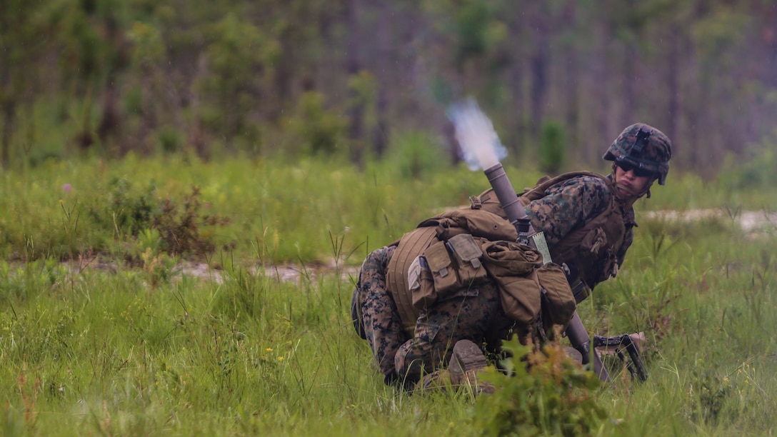 A mortar team with 1st Battalion, 2nd Marine Regiment, take cover on the firing line as a mortar round shoots out of the barrel during a training exercise at Camp Lejeune, N.C., June 6, 2016. Marines underwent mortar familiarization and proficiency training in preparation for their upcoming deployment in support of Special-Purpose Marine Air-Ground Task Force. 