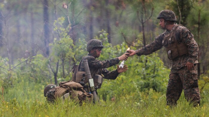 A mortarman with 1st Battalion, 2nd Marine Regiment, 2nd Marine Division, receives a primed mortar round during a training exercise at Camp Lejeune, N.C., June 6, 2016. Marines underwent mortar familiarization and proficiency training in preparation for their upcoming deployment in support of Special-Purpose Marine Air-Ground Task Force. 