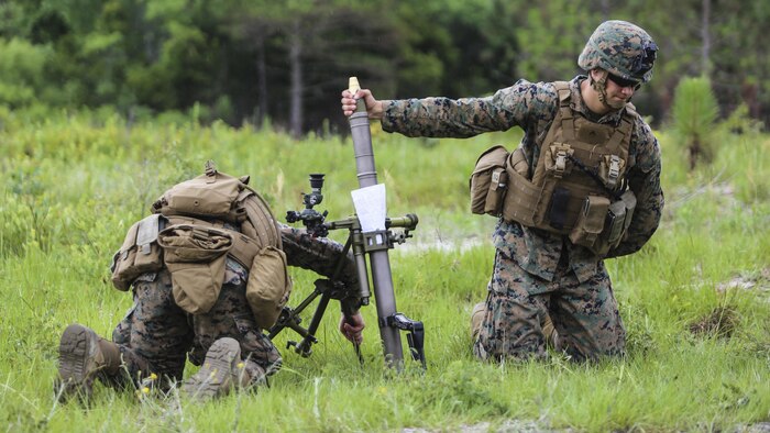 The gunner of a mortar team with 1st Battalion, 2nd Marine Regiment, 2nd Marine Division, prepares to drop a round into the mortar barrel at Camp Lejeune, N.C., June 6, 2016. Marines underwent mortar familiarization and proficiency training in preparation for their upcoming deployment in support of Special-Purpose Marine Air-Ground Task Force. 
