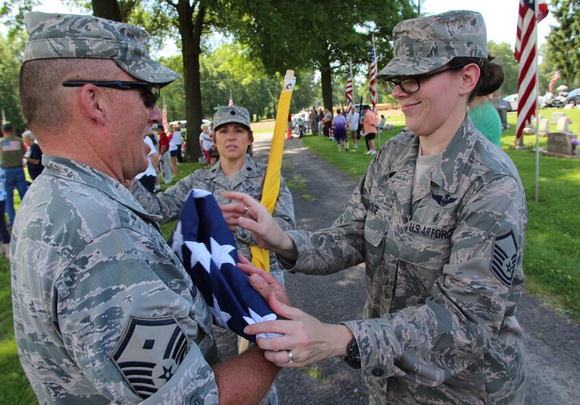 Volunteers of the 932nd Airlift Wing gave of their time to think of other military veterans who went before them in history, and sometimes gave the ultimate sacrifice of their lives.  932nd Medical Group First Sergeant Sean Murname (left), and 932nd Director of Staff, Lt. Col. Julie Novy (center), along with former 932nd Honor Guard member, Master Sgt. Karen Ridge, worked together last week to fold the American flag back into its proper position at the end of their parade route and Memorial Day events.  The 932nd Airlift Wing had a great group of enthusiastic volunteers who carried the Air Force Reserve Command banner and represented the unit in the Belleville parade.  The wing plans to help in the Saint Louis VP parade on July 2, and that event will start at 10:00 a.m. near 7th and Market streets.(U.S. Air Force photo by Maj. Stan Paregien)