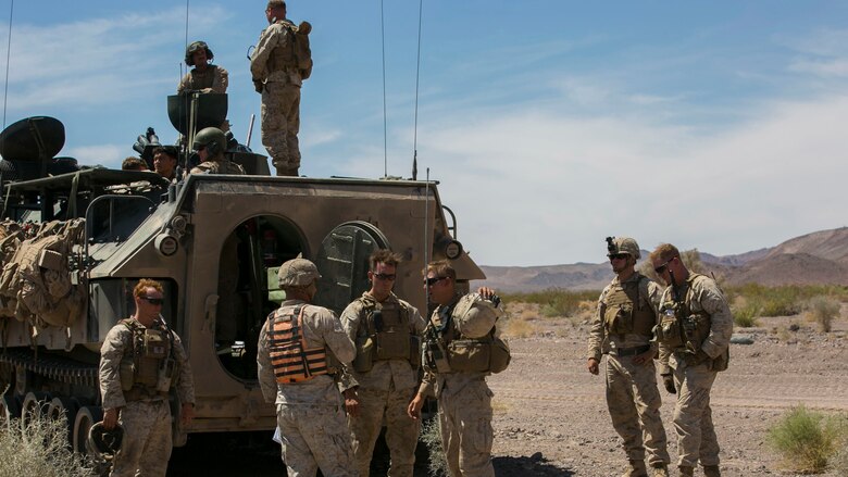 Capt. David Orick, training and plans officer, Tactical Training Exercise Control Group, speaks with Marines during the final exercise of Integrated Training Exercise 3-16 in the Blacktop Training Area at Marine Corps Air Ground Combat Center, Twentynine Palms, California, June 1, 2016. 
