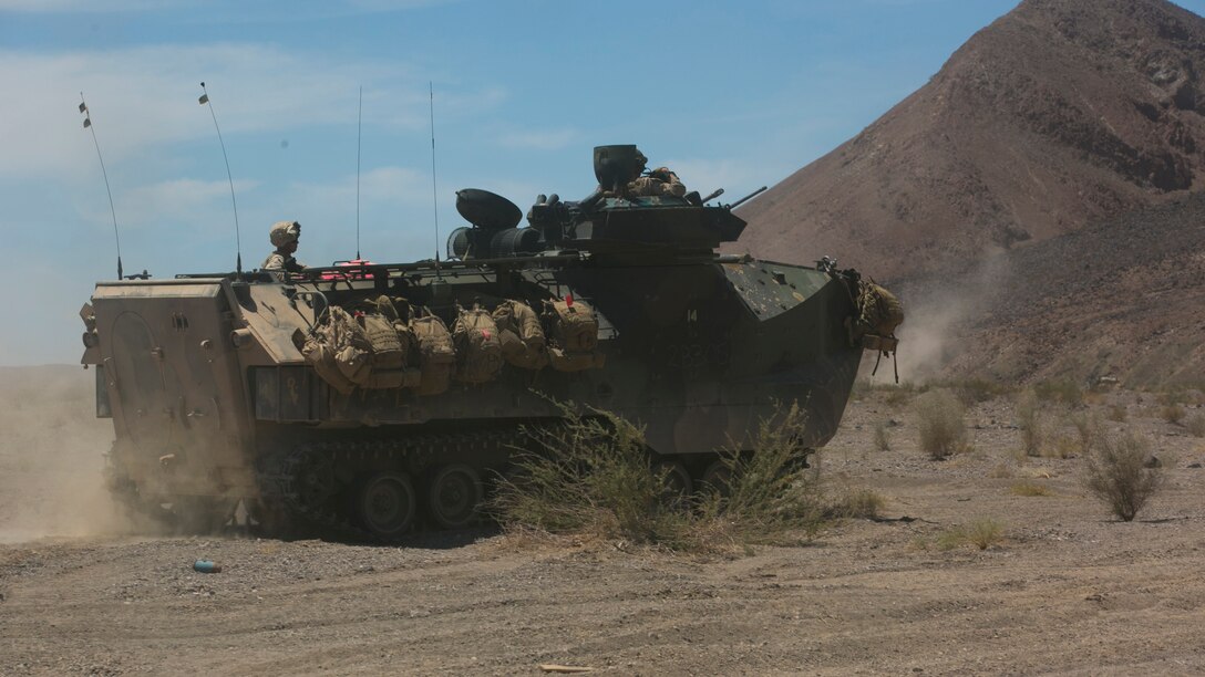 Marines with 3rd Battalion, 2nd Marine Regiment, advance to a simulated enemy defensive position in an Assault Amphibious Vehicle during the final exercise of Integrated Training Exercise 3-16 in the Blacktop Training Area at Marine Corps Air Ground Combat Center, Twentynine Palms, California, June 1, 2016. 
