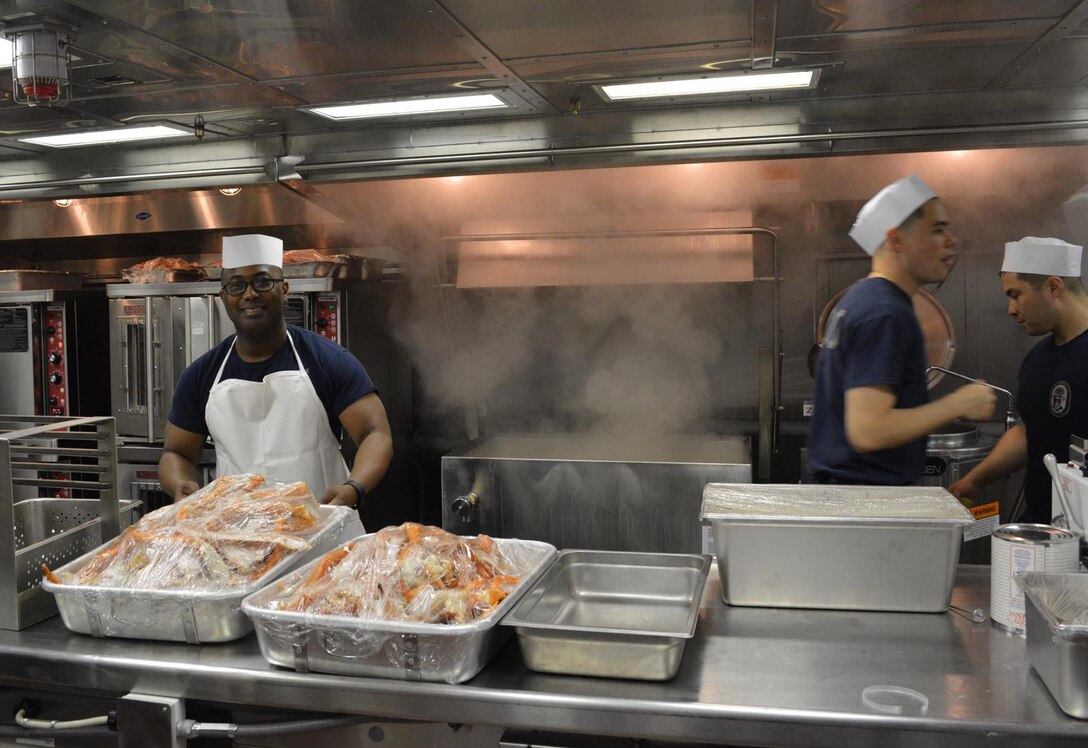 After the Navy took ownership of the USS Zumwalt (DDG 1000), the supply department works to feed sailors aboard the destroyer May 20 in Bath, Maine. The Zumwalt’s inaugural dinner included lobster tail, crab and filet mignon.