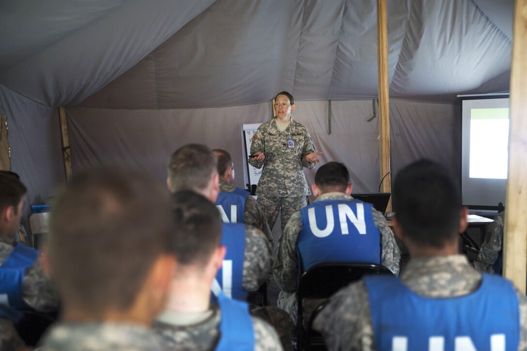Army Staff Sgt. Heather Percy, center, explains the basic concepts of combat medical care to soldiers during the combat medical care training lane of Khaan Quest 2016 at Five Hills training area near Ulaanbaatar, Mongolia, May 30, 2016. The soldiers are assigned to the Alaska Army National Guard. The annual exercise evaluates soldiers on essential life-saving skills and the ability to prioritize injuries and medical care. Marine Corps photo by Cpl. Janessa K. Pon