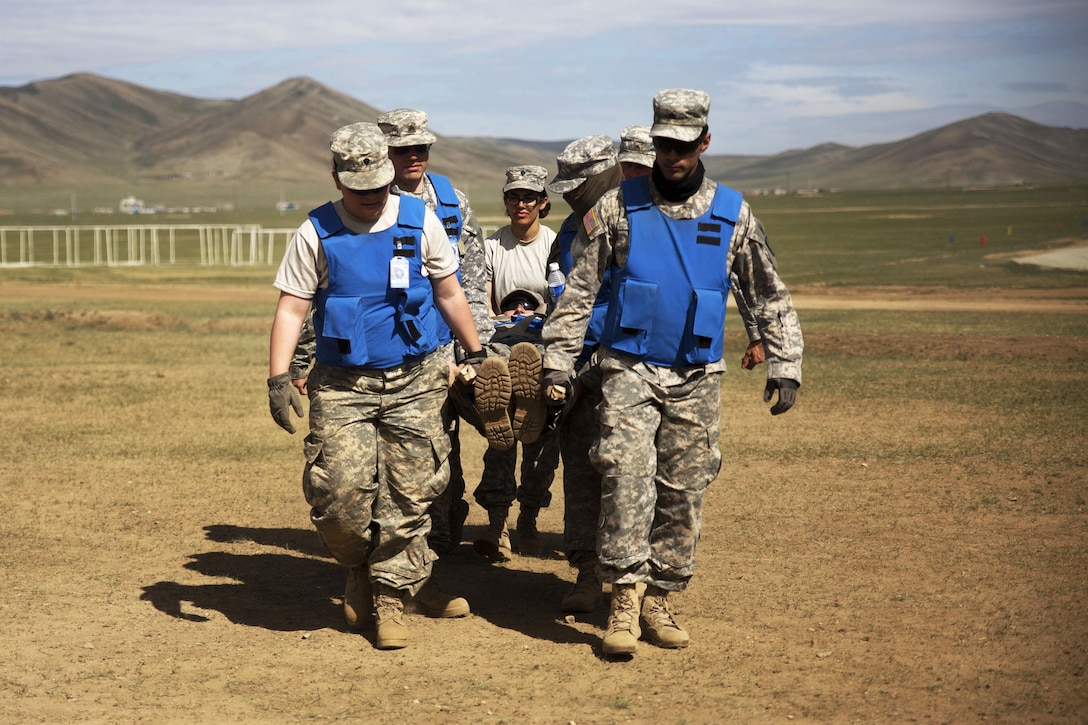 Soldiers carry a simulated casualty on a litter during combat medical care training in Khaan Quest 2016 at Five Hills training area near Ulaanbaatar, Mongolia, May 30, 2016. Marine Corps photo by Cpl. Janessa K. Pon