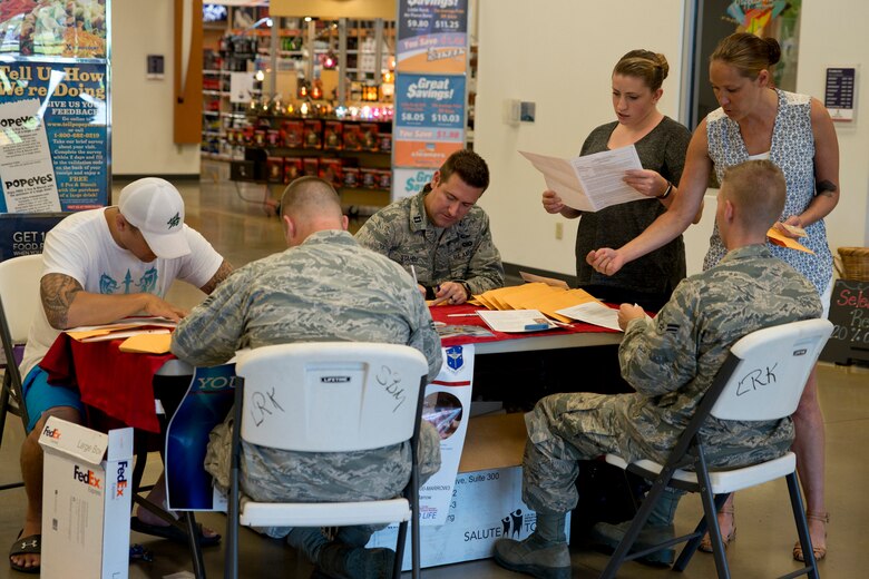 Volunteers help with the C. W. Bill Young Department of Defense Marrow Donor Program registration process in the Base Exchange at Little Rock Air Force Base, Ark., June 7, 2016. The recruitment drive, which was coordinated by the 19th Security Forces Squadron and Rising 6 organization on base, gave members an opportunity to join the fight against blood cancer by becoming potential bone marrow donors. Since its inception in 1991, the DoD Marrow Program has recruited more than 800,000 individuals in the fight against blood cancer. (U.S. Air Force photo by Master Sgt. Jeff Walston/Released)  