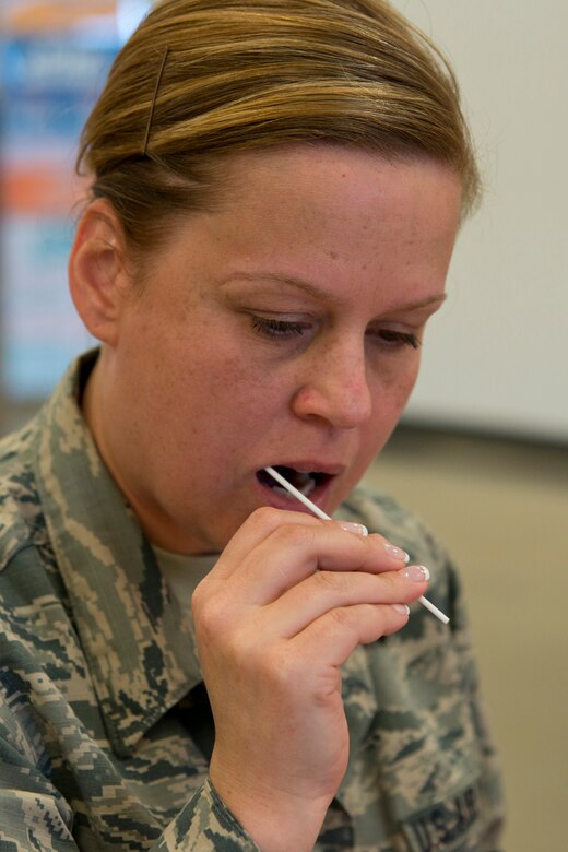 U.S. Air Force Reserve Tech. Sgt. Debra Gentry, NCOIC, commander support, 96th Aerial Port Squadron, 913th Airlift Group, swabs skin cells from the inside of her cheek in the Base Exchange at Little Rock Air Force Base, Ark., June 7, 2016. Gentry, who lost a sister to bone cancer, registered with the C. W. Bill Young Department of Defense Marrow Donor Program during a recruitment drive coordinated by the 19th Security Forces Squadron and Rising 6 organization. (U.S. Air Force photo by Master Sgt. Jeff Walston/Released)  