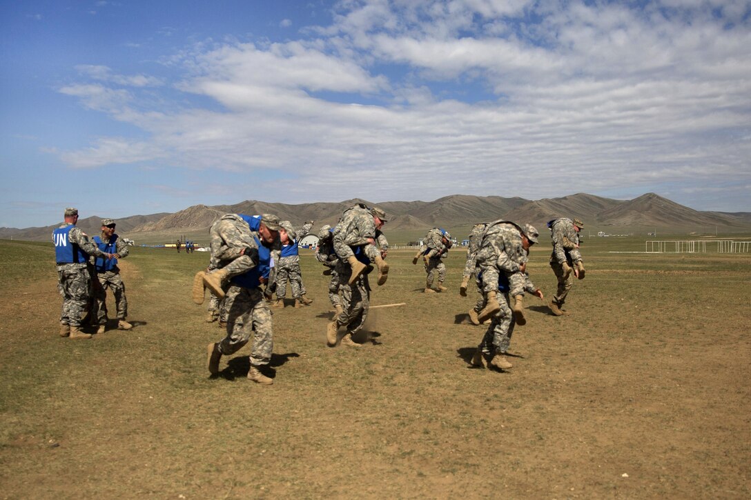 Soldiers practice patient transportation using the firemen’s carry technique during the combat medical care training lane of Khaan Quest 2016 at Five Hills training area near Ulaanbaatar, Mongolia, May 30, 2016. Marine Corps photo by Cpl. Janessa K. Pon