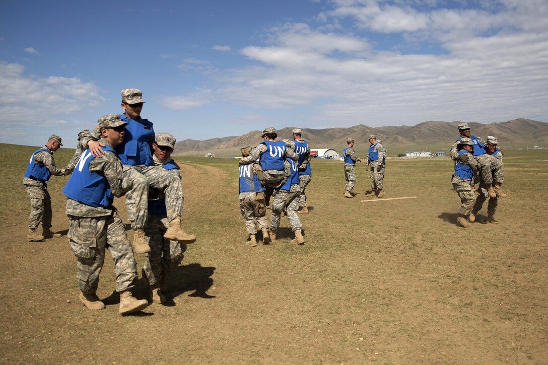 Soldiers practice patient transportation using the buddy technique during the combat medical care training lane of Khaan Quest 2016 at Five Hills training area near Ulaanbaatar, Mongolia, May 30, 2016. Marine Corps photo by Cpl. Janessa K. Pon