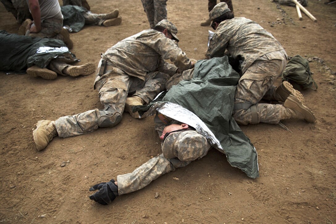 Soldiers cover a simulated patient after providing medical care during a practical application exercise in the combat medical care training lane of Khaan Quest 2016 at Five Hills training area near Ulaanbaatar, Mongolia, May 30, 2016. Marine Corps photo by Cpl. Janessa K. Pon