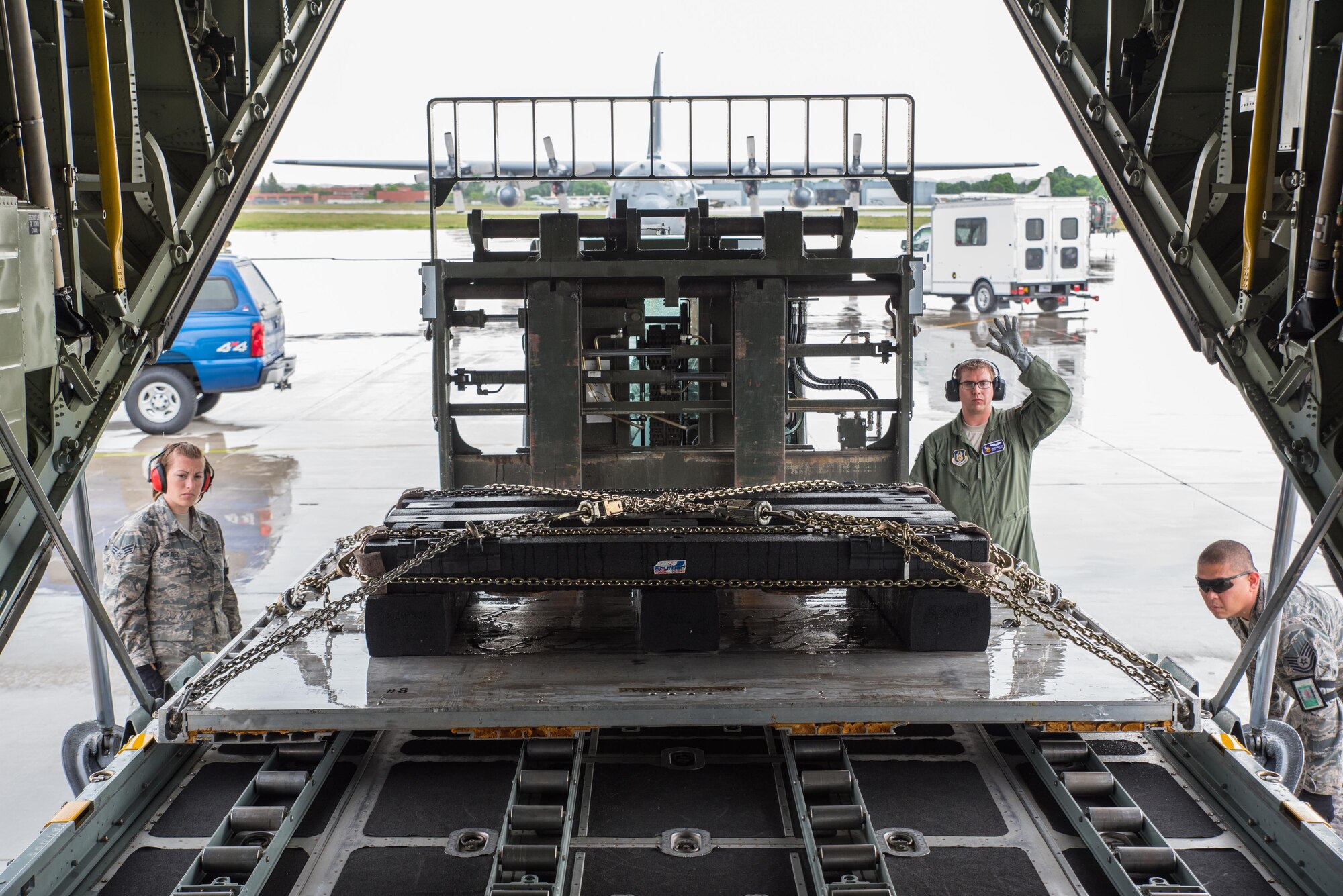 Staff Sgt. James Goetze, a loadmaster from the 96th Airlift Squadron, guides a load onto the aircraft with the assistance of Tech. Sgt. Jerome Wy and Senior Airman Breanna Moravec of the 27th Aerial Port Squadron . (U.S. Air Force photo by Master Sgt. Eric Amidon)