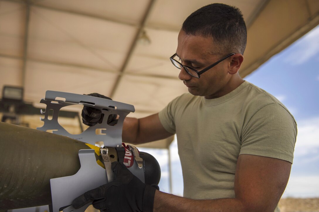 Air Force Staff Sgt. Alejandro Medina helps build a GBU-54 munition at Bagram Airfield, Afghanistan, May 26, 2016. Medina is a munitions system specialist assigned to the 455th Expeditionary Maintenance Squadron. Air Force photo by Senior Airman Justyn M. Freeman