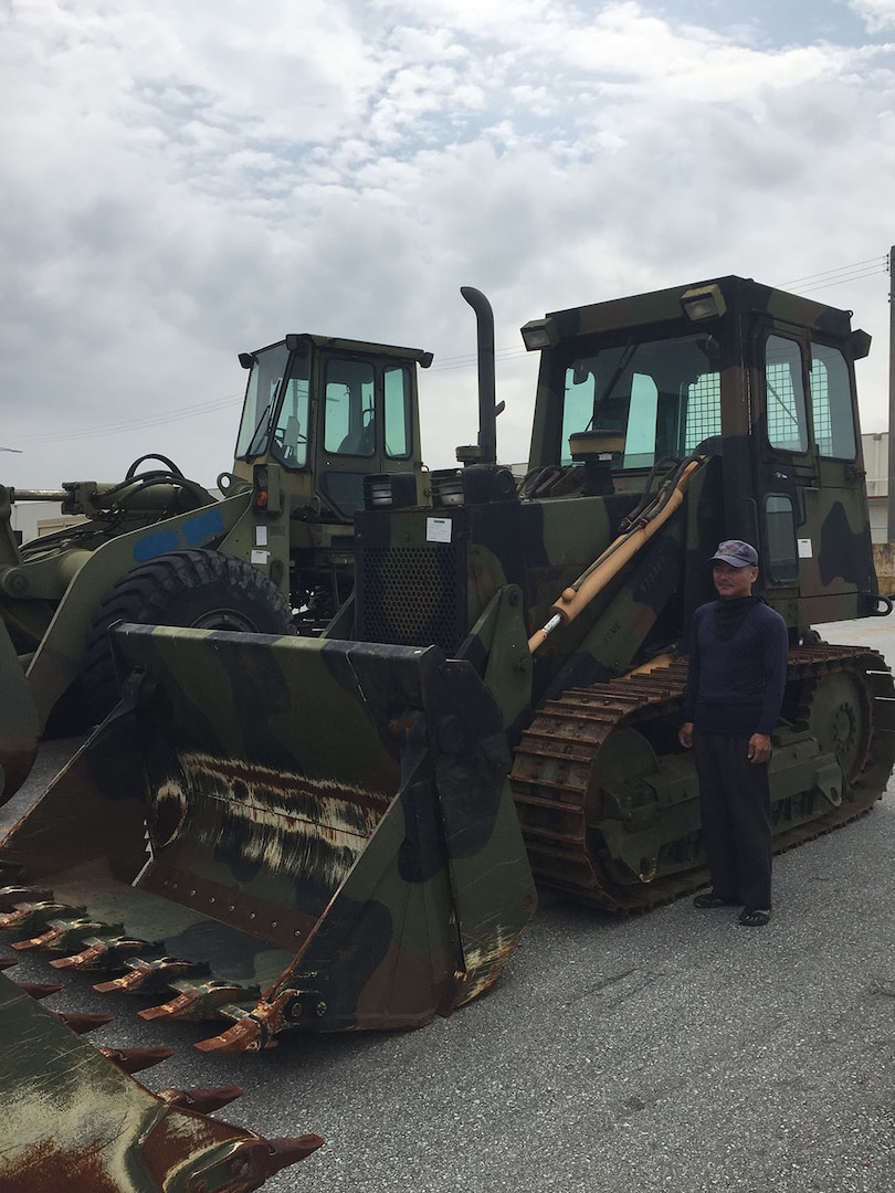 Satoru Matsuda, a forklift operator at DLA Disposition Services at Okinawa looks over one of the extra-large items that had to arrive late at night to meet local road restrictions.