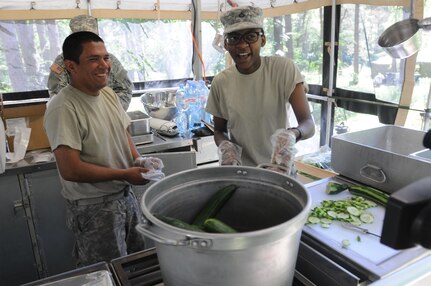 Pfc. Gabriel Royz and Pfc. Babrah Mumeld prepare dinner from a Mobile Kitchen Trailer during Anakonda 16 at the Drawsko Pomoriskie Training Area in Poland. Exercise Anakonda 16 is a Polish-led, joint, multinational exercise taking place in from June 7-17. Royz is from Everson, Wash., and Mumeld is from Seattle, Wash., both soldiers are assigned to the 483rd Quartermaster Company based in Marysville, Wash. (Photo by Sgt. Dennis Glass)