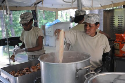 Pfc. Babrah Mumeld and Pvt. Zenetria Williams prepare dinner from a Mobile Kitchen Trailer during Anakonda 16 at the Drawsko Pomoriskie Training Area in Poland. Exercise Anakonda 16 is a Polish-led, joint, multinational exercise taking place in Poland from June 7-17. Mumeld is from Seattle, Wash., and assigned to the 483rd Quartermaster Company based in Marysville, Wash. Williams from Brooklyn, NY assigned to 716th Quartermaster Company based in Jersey City, NJ. (Photo by Sgt. Dennis Glass)