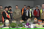 Brig. Gen. Andrew Rohling (center), U.S. Forces Afghanistan Deputy Deputy Commanding General-Support, receives a briefing from Anham personnel during a recent facility tour. Anham provides all the food that warfighters consume in Afghanistan.