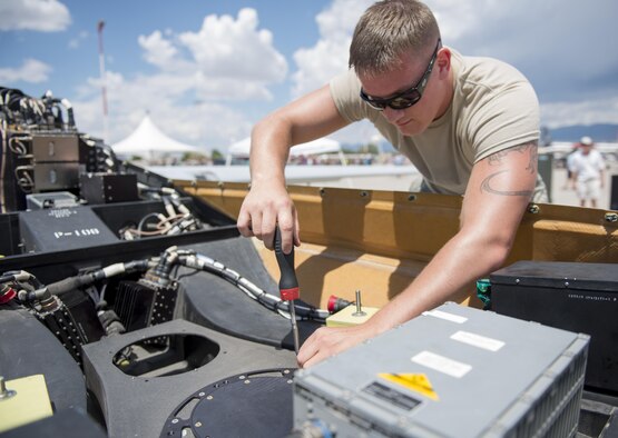 Senior Airman Thomas, a 9th Aircraft Maintenance Unit avionics specialist at Holloman Air Force Base, N.M., assembles an MQ-1 Predator at Kirtland AFB on June 4. Over 50,000 people visited the Kirtland AFB Open House on June 4 and 5. Holloman Airmen had the opportunity to display an MQ-1 Predator and answer questions visitors had about RPAs and their mission at Holloman. (Last names are being withheld due to operational requirements. U.S. Air Force photo by Airman 1st Class Randahl J. Jenson) 