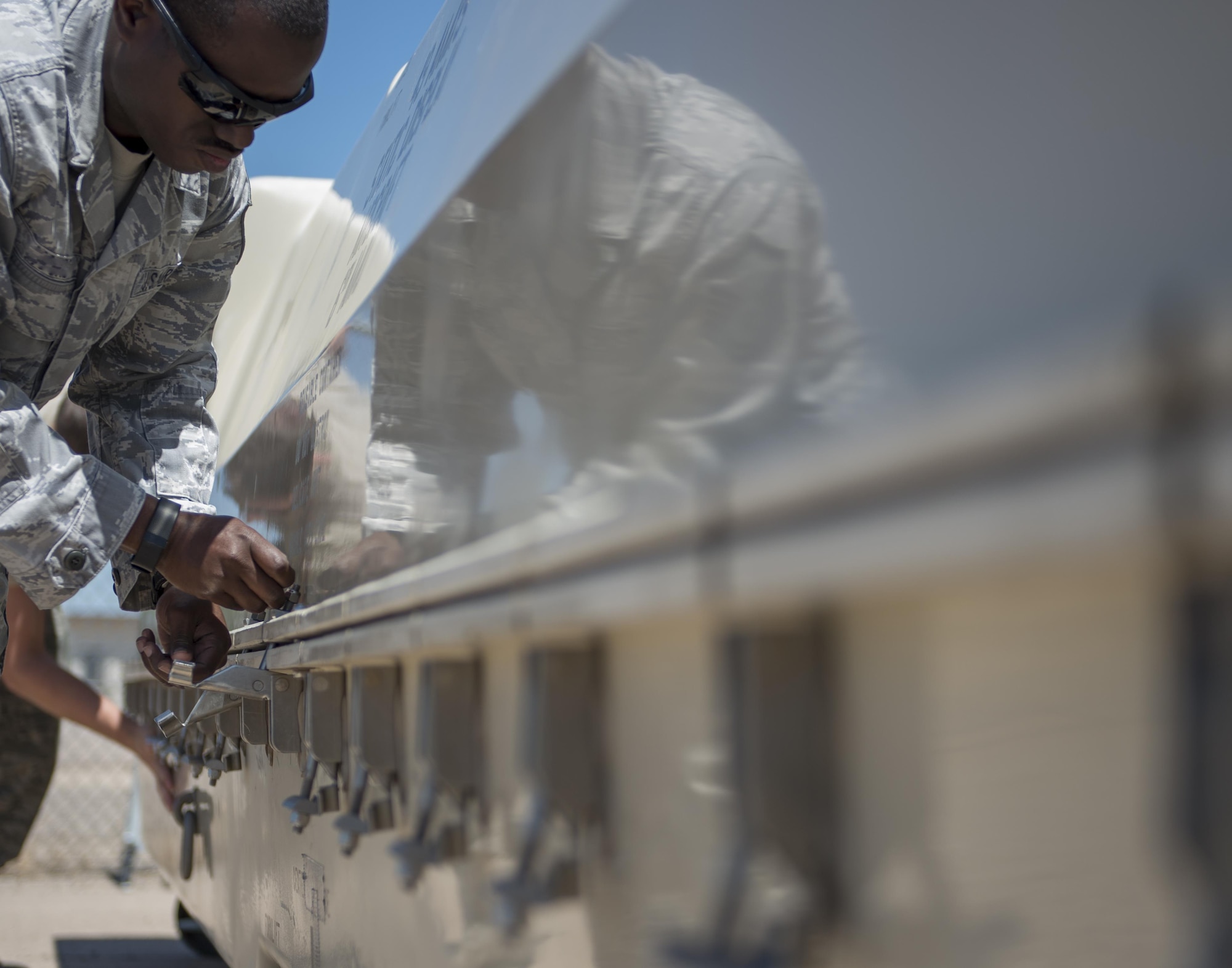 Master Sgt. Robert, a 9th Aircraft Maintenance Unit specialist section chief at Holloman Air Force Base, N.M., unlatches the container housing an MQ-1 Predator at Kirtland AFB on June 3. Over 50,000 people visited the Kirtland AFB Open House on June 4 and 5. Holloman Airmen had the opportunity to display an MQ-1 Predator and answer questions visitors had about RPAs and their mission at Holloman. (Last names are being withheld due to operational requirements. U.S. Air Force photo by Airman 1st Class Randahl J. Jenson) 