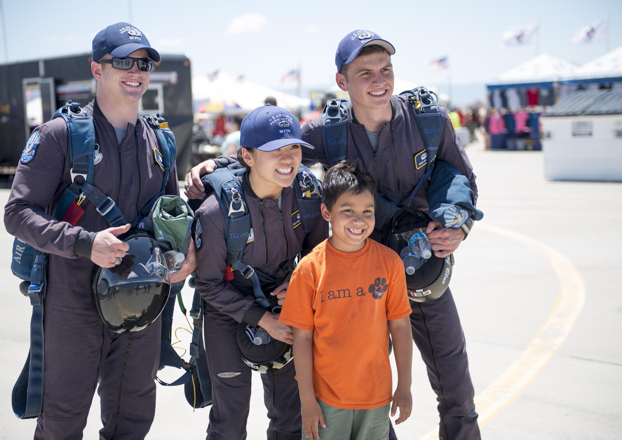 Cadets from the Air Force’s Wings of Blue pose for a photo with a visitor during the Kirtland Air Force Base Open House on June 5. Wings of Blue cadets performed several jumps during the open house, demonstrating their talent and presenting the flag for the national anthem. (U.S. Air Force photo by Airman 1st Class Randahl J. Jenson) 