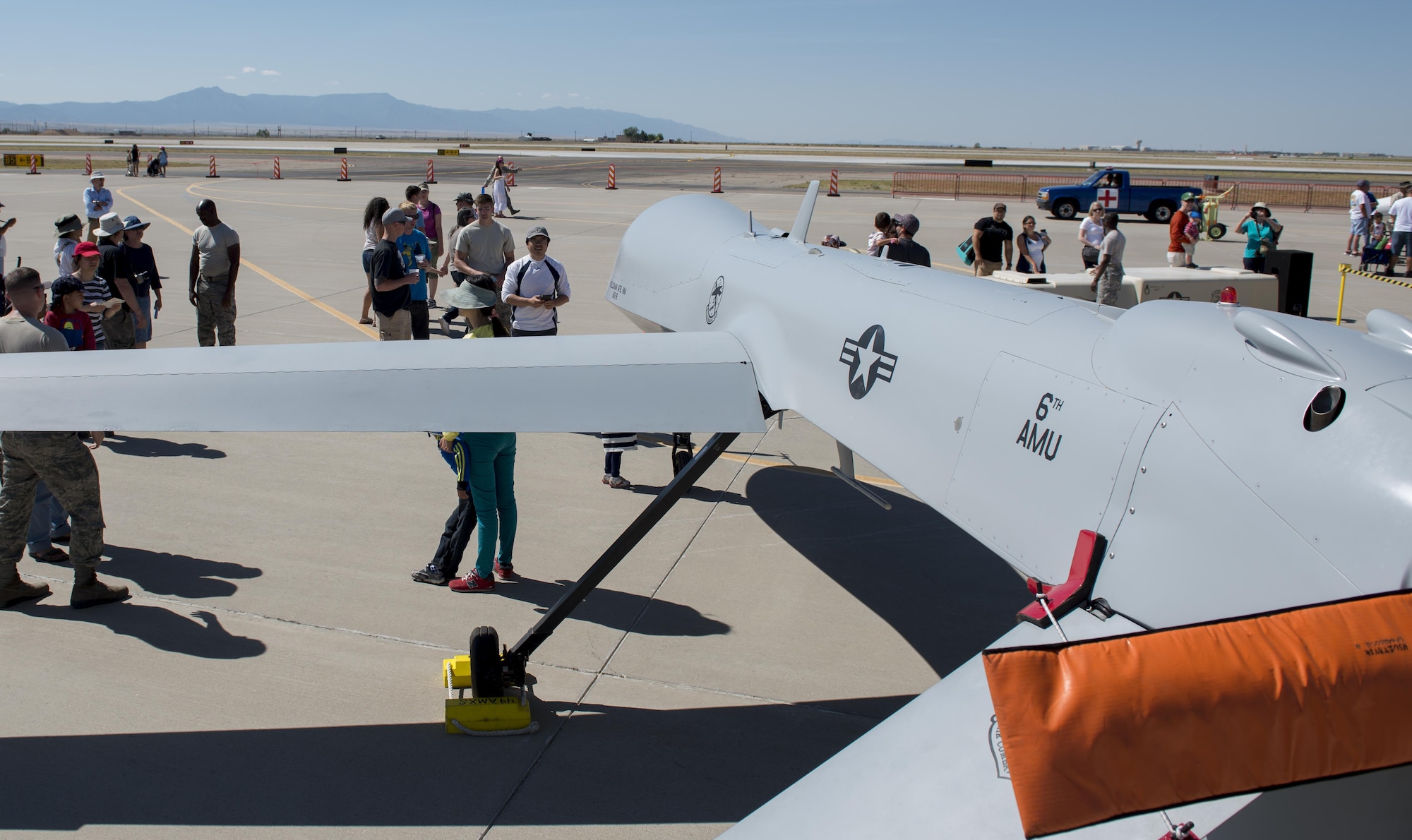 Visitors view an MQ-1 Predator at Kirtland Air Force Base, N.M. on June 5. Visitors to the open house were able to walk around the Remotely Piloted Aircraft and ask questions to Holloman Airmen regarding the aircraft and their mission at Holloman. (U.S. Air Force photo by Airman 1st Class Randahl J. Jenson)