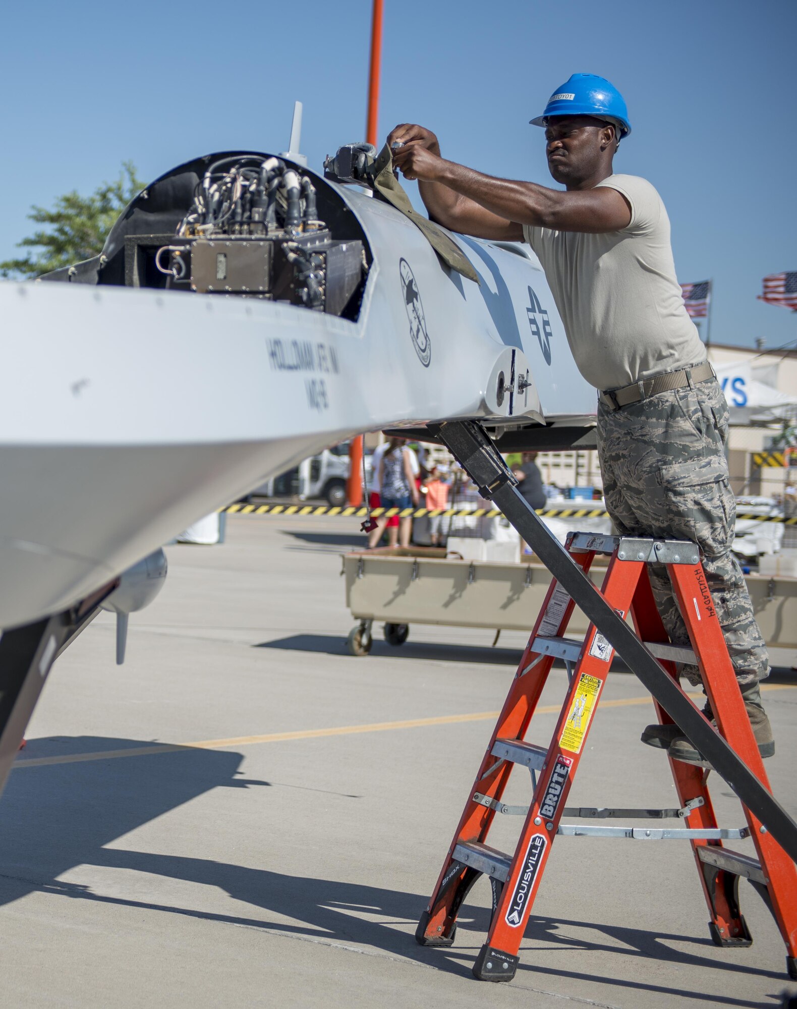 Staff Sgt. Omoro, a 9th Aircraft Maintenance Unit demo team leader at Holloman Air Force Base, N.M., assembles an MQ-1 Predator for the Kirtland AFB Open House on June 4. Holloman Airmen were able to fully construct the model MQ-1 Predator from a cargo container in 31 minutes. (Last names are being withheld due to operational requirements. U.S. Air Force photo by Airman 1st Class Randahl J. Jenson) 