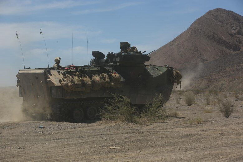 Marines with 3rd Battalion, 2nd Marine Regiment, advance to a simulated enemy defensive position in an Assault Amphibious Vehicle during the final exercise of Integrated Training Exercise 3-16 in the Blacktop Training Area aboard Marine Corps Air Ground Combat Center, Twentynine Palms, Calif., June 1, 2016. (Official Marine Corps photo by Lance Cpl. Dave Flores/Released)