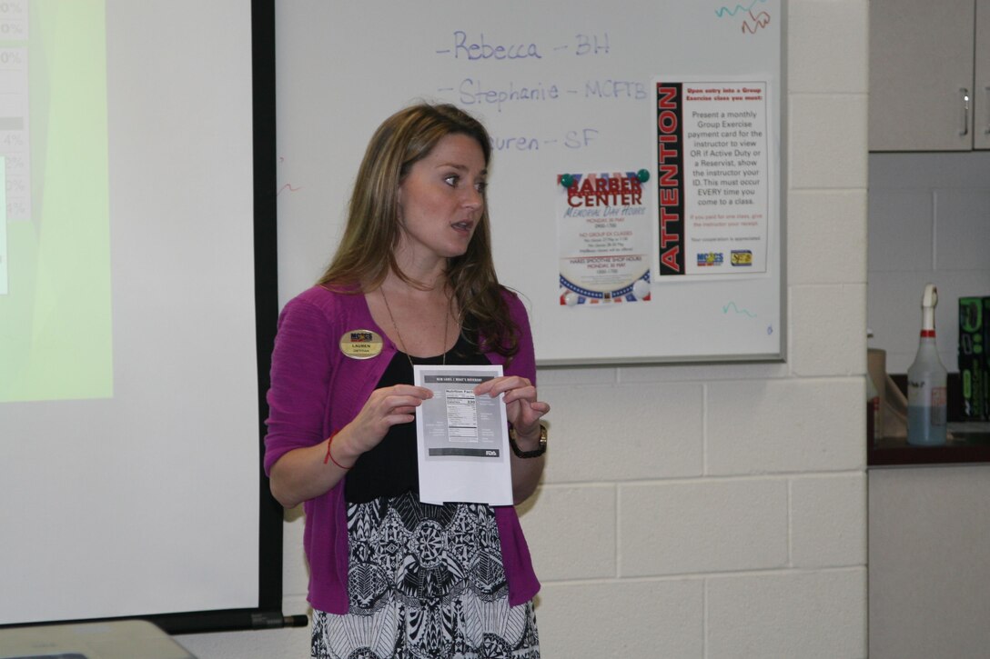 Semper Fit dietitian Lauren King shows students at her June 1 "Supermarket Savvy" nutrition class how to read the newly-revised USDA nutrition labels. The labels will now show the amount of added sugar, Vitamin D, and potassium in the product. The class also offered tips for shopping for healthy food on a budget. 