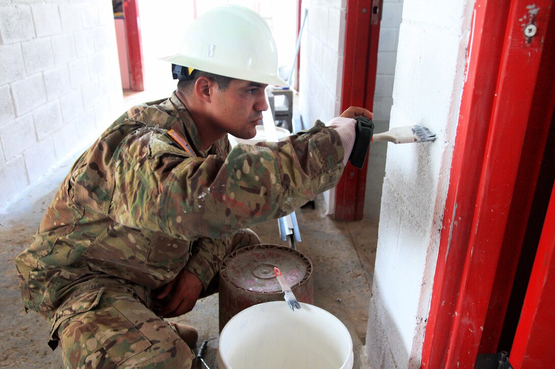 Army Staff Sgt. Michael Gonzales puts the finishing touch on a wall as soldiers build a new school for Guatemalan children during Beyond the Horizon 2016 in Tocache, Guatemala, June 2, 2016. Gonzales is assigned to the 1021st Engineer Company. Army photo by Spc. Tamara Cummings